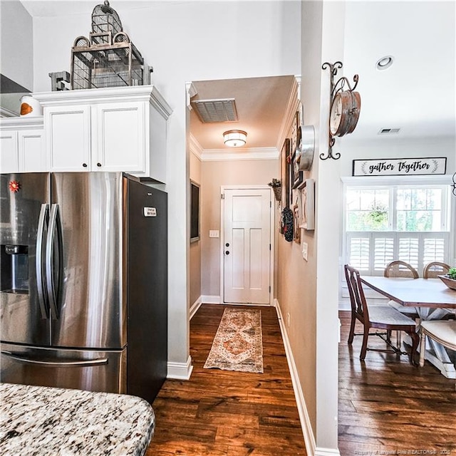 1303 Palestine Rd, Linden, NC 28356 - kitchen with stainless steel fridge with ice dispenser, dark wood-style flooring, ornamental molding, white cabinets, and baseboards