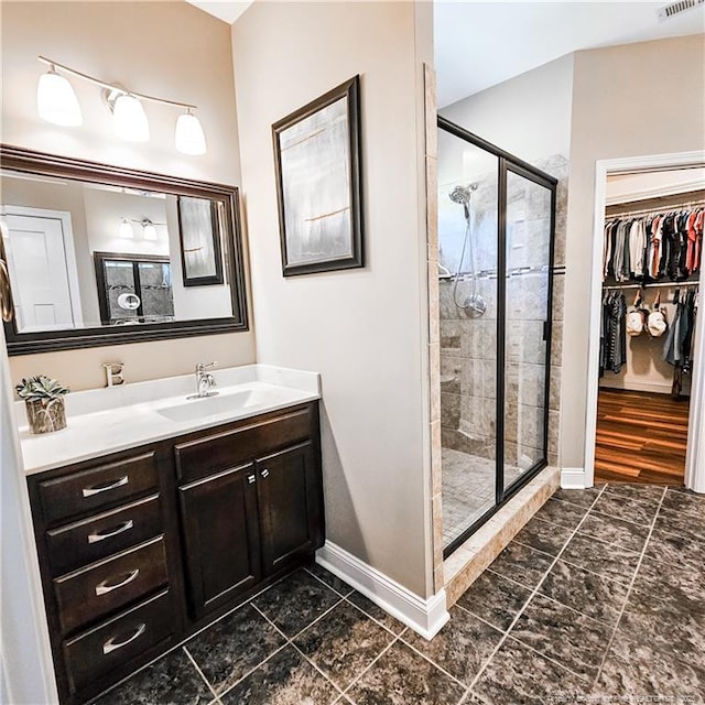 1303 Palestine Rd, Linden, NC 28356 - bathroom with a shower stall, vanity, baseboards, and a walk in closet