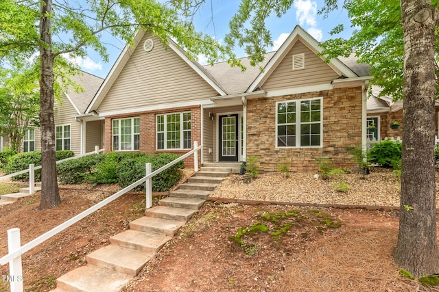 11220 Avocet Ln Unit 104, Raleigh, NC 27617 - view of front of house featuring roof with shingles and stone siding