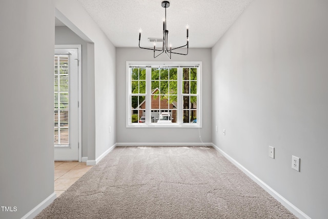11220 Avocet Ln Unit 104, Raleigh, NC 27617 - spare room featuring carpet, a chandelier, a textured ceiling, baseboards, and a heating unit