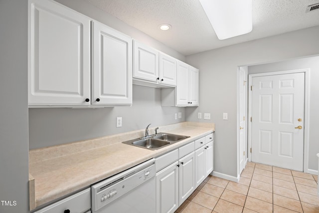 11220 Avocet Ln Unit 104, Raleigh, NC 27617 - kitchen with dishwasher, a sink, a textured ceiling, white cabinetry, and light countertops
