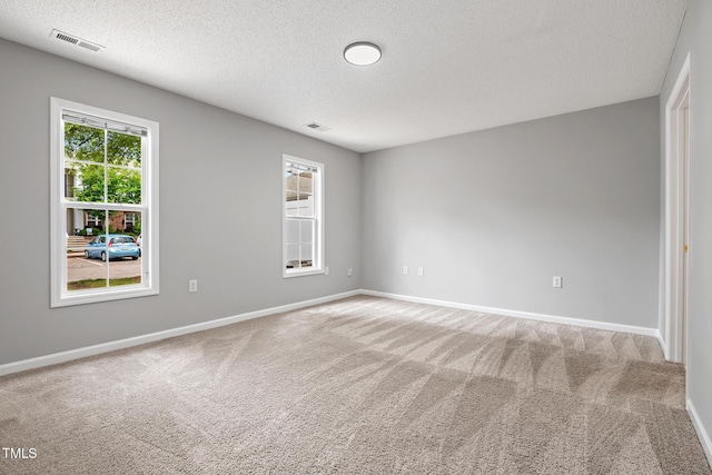 11220 Avocet Ln Unit 104, Raleigh, NC 27617 - carpeted empty room with a textured ceiling and baseboards
