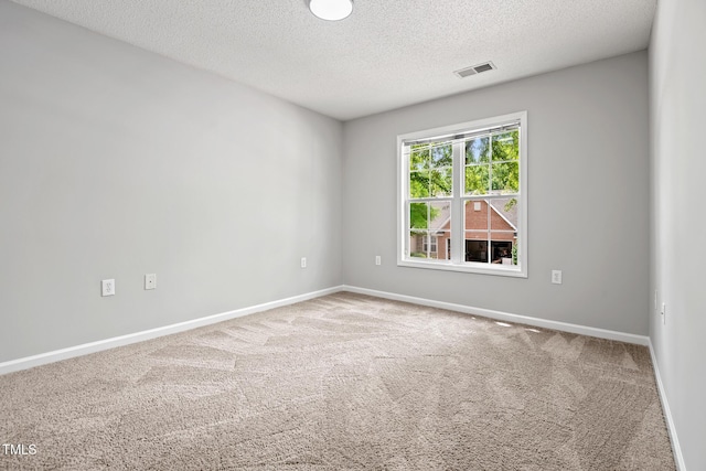 11220 Avocet Ln Unit 104, Raleigh, NC 27617 - empty room with a textured ceiling, carpet flooring, and baseboards