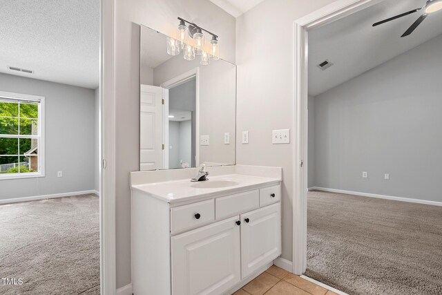 11220 Avocet Ln Unit 104, Raleigh, NC 27617 - bathroom featuring ceiling fan, baseboards, vanity, and a textured ceiling