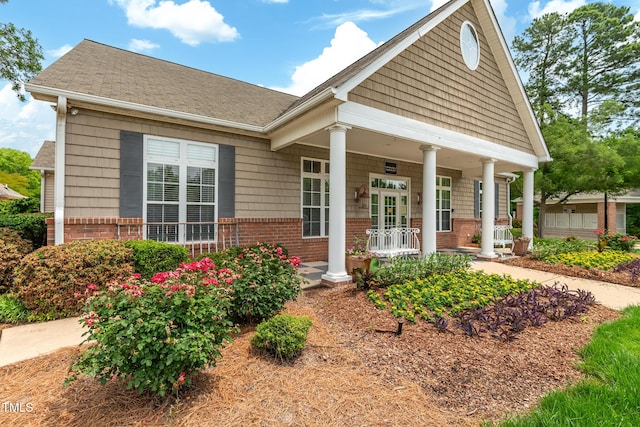 11220 Avocet Ln Unit 104, Raleigh, NC 27617 - neoclassical home with brick siding, a porch, and roof with shingles