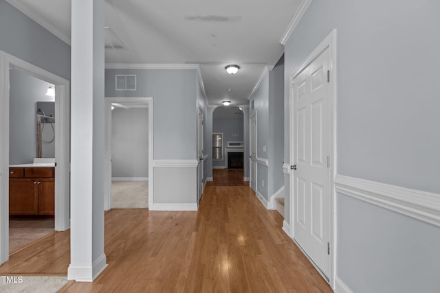 39 Mcguire Ln, Clayton, NC 27527 - corridor featuring light wood-style floors, ornamental molding, baseboards, and arched walkways