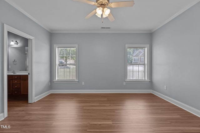 39 Mcguire Ln, Clayton, NC 27527 - unfurnished bedroom with wood finished floors, crown molding, baseboards, and a sink