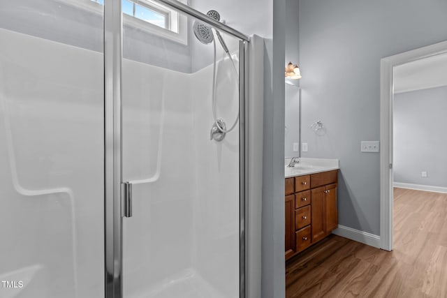 39 Mcguire Ln, Clayton, NC 27527 - bathroom featuring a shower stall, wood finished floors, vanity, and baseboards