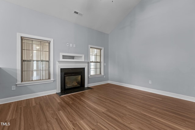 39 Mcguire Ln, Clayton, NC 27527 - unfurnished living room with a glass covered fireplace, wood finished floors, baseboards, and high vaulted ceiling