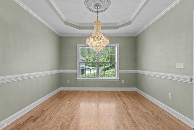 39 Mcguire Ln, Clayton, NC 27527 - empty room featuring a chandelier, a raised ceiling, wood finished floors, baseboards, and ornamental molding