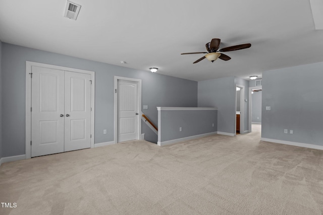 39 Mcguire Ln, Clayton, NC 27527 - unfurnished living room with a ceiling fan, light colored carpet, and baseboards