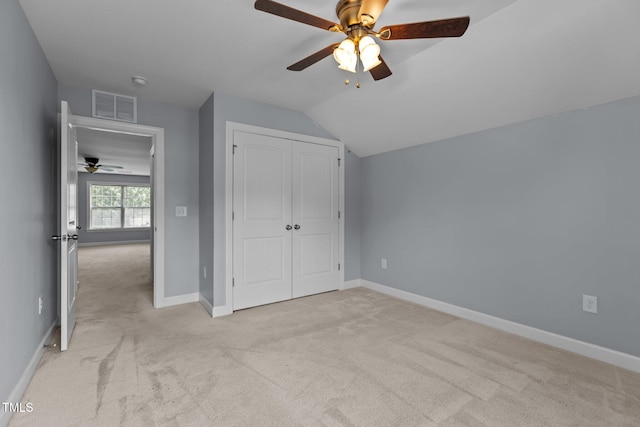 39 Mcguire Ln, Clayton, NC 27527 - unfurnished bedroom featuring light carpet, lofted ceiling, and baseboards