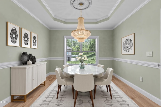 39 Mcguire Ln, Clayton, NC 27527 - dining space with a chandelier, a tray ceiling, wood finished floors, baseboards, and ornamental molding