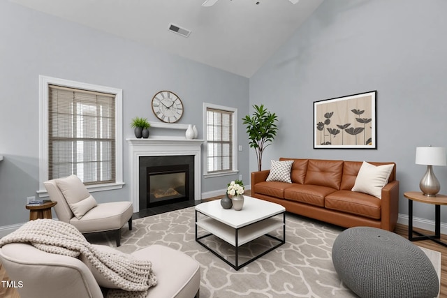 39 Mcguire Ln, Clayton, NC 27527 - living room featuring baseboards, plenty of natural light, wood finished floors, high vaulted ceiling, and ceiling fan
