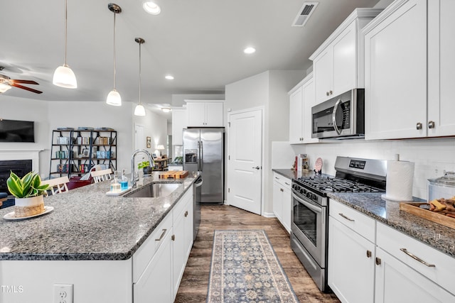 1096 Aberlour Ln, Burlington, NC 27215 - kitchen featuring appliances with stainless steel finishes, a sink, a ceiling fan, dark wood-style flooring, and backsplash