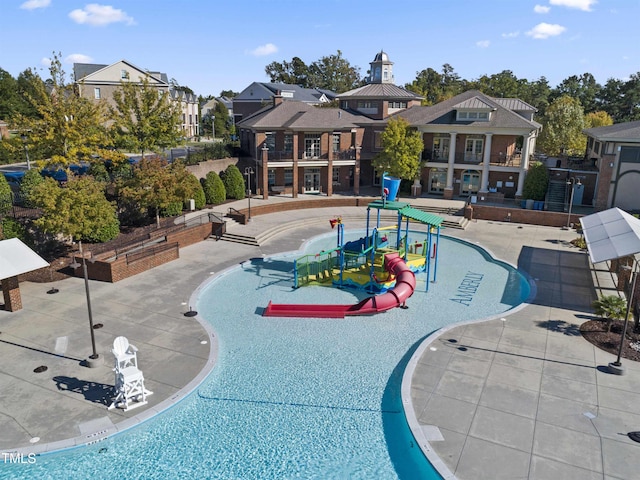 view of pool with a water play area