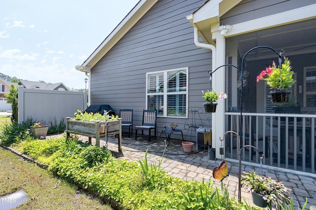 property entrance featuring a patio area and fence