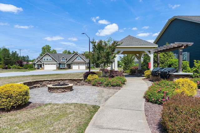 view of yard featuring a fire pit and a pergola