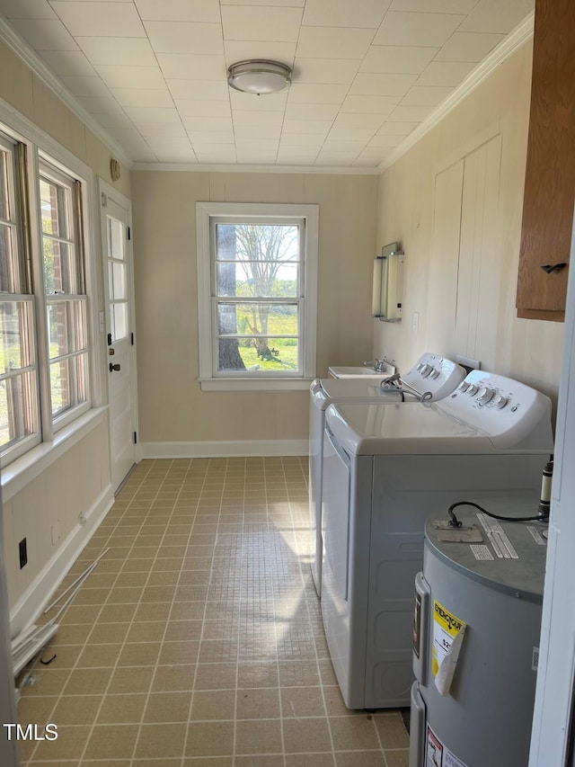 laundry room with washer and dryer, ornamental molding, water heater, baseboards, and cabinet space