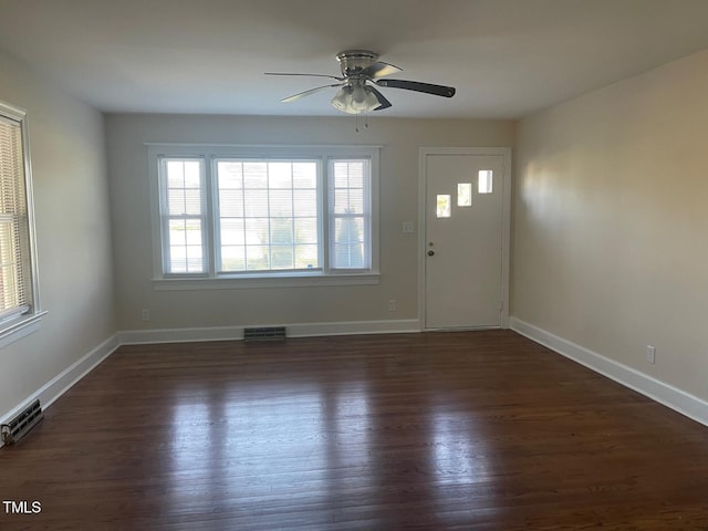 entrance foyer featuring ceiling fan, dark wood finished floors, and baseboards