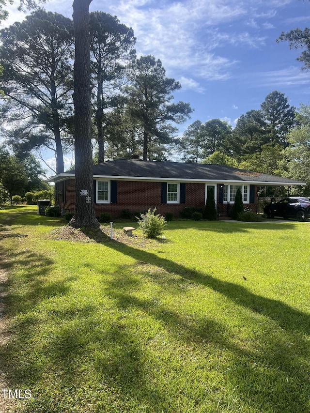 ranch-style home with a front lawn and brick siding