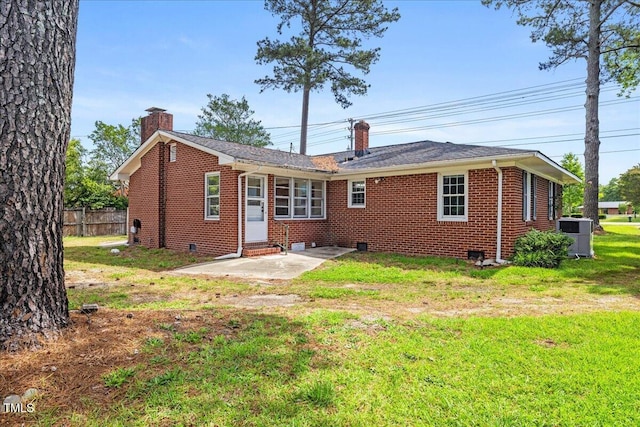 5345 Lamm Rd, Wilson, NC 27893 - rear view of house with a chimney, brick siding, entry steps, and central AC