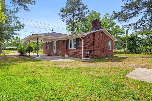 5345 Lamm Rd, Wilson, NC 27893 - back of house with a chimney, a lawn, brick siding, and crawl space