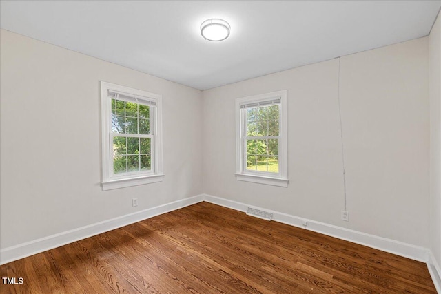 5345 Lamm Rd, Wilson, NC 27893 - empty room with baseboards, plenty of natural light, and dark wood-style floors