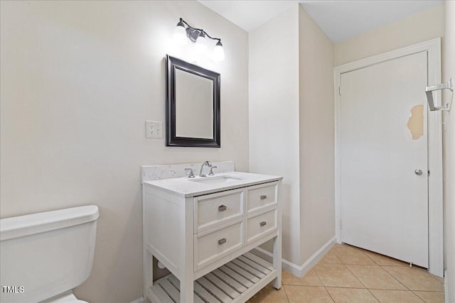 5345 Lamm Rd, Wilson, NC 27893 - half bathroom featuring toilet, vanity, tile patterned flooring, and baseboards