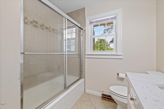 5345 Lamm Rd, Wilson, NC 27893 - bathroom featuring toilet, tile patterned floors, vanity, baseboards, and shower / bath combination with glass door