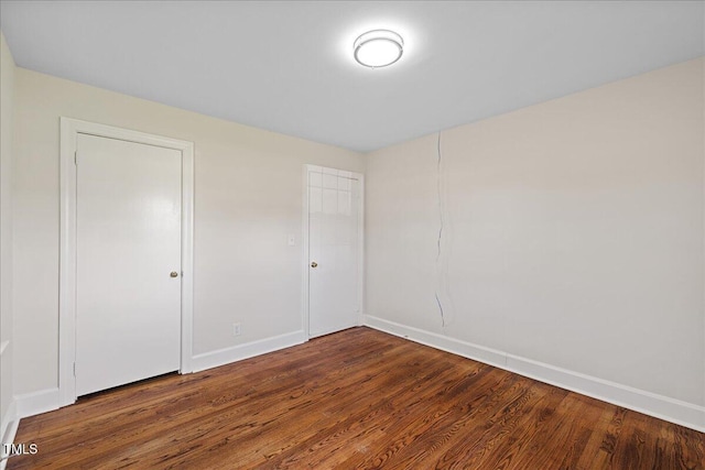 5345 Lamm Rd, Wilson, NC 27893 - unfurnished bedroom with wood finished floors and baseboards