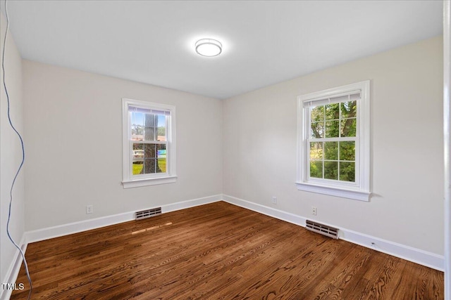 5345 Lamm Rd, Wilson, NC 27893 - unfurnished room featuring plenty of natural light, dark wood-type flooring, and baseboards