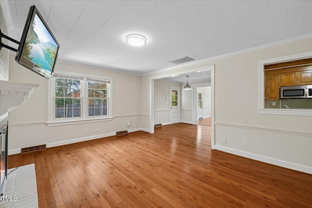 5345 Lamm Rd, Wilson, NC 27893 - unfurnished living room with wood-type flooring, crown molding, and baseboards
