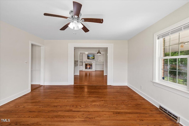 5345 Lamm Rd, Wilson, NC 27893 - spare room with wood finished floors, baseboards, a ceiling fan, and a baseboard radiator
