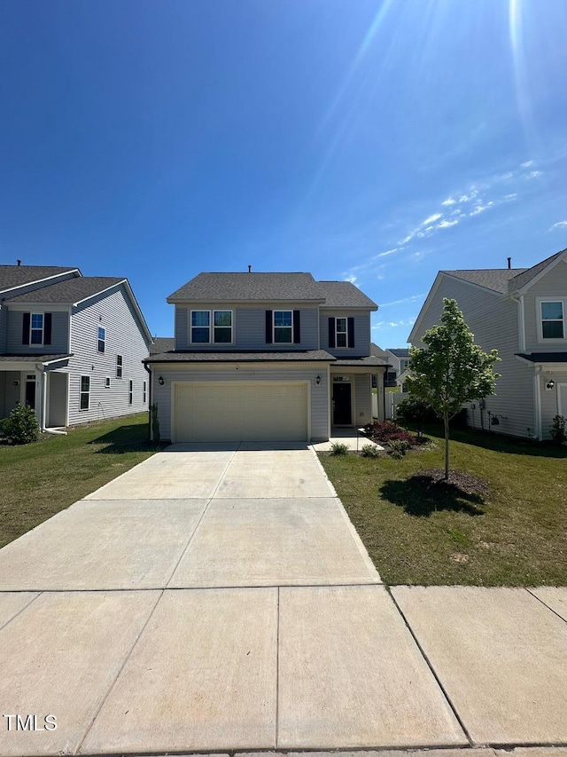 99 Still Hand Dr, Clayton, NC 27527 - traditional-style home featuring concrete driveway, an attached garage, and a front yard