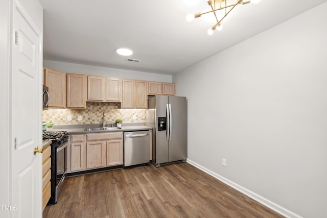 8610 Neuse Landing Ln Unit 103, Raleigh, NC 27616 - kitchen with stainless steel appliances, light brown cabinets, a sink, and dark wood-style floors