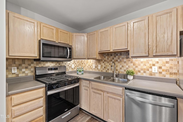 8610 Neuse Landing Ln Unit 103, Raleigh, NC 27616 - kitchen featuring appliances with stainless steel finishes, light brown cabinetry, a sink, and backsplash