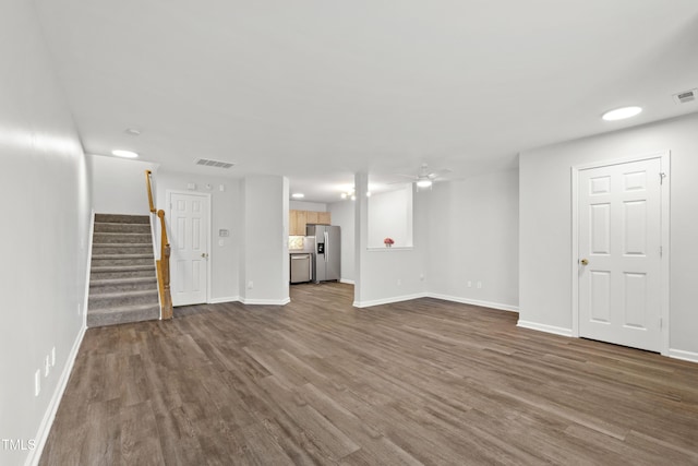 8610 Neuse Landing Ln Unit 103, Raleigh, NC 27616 - unfurnished living room featuring dark wood finished floors, stairs, ceiling fan, and baseboards