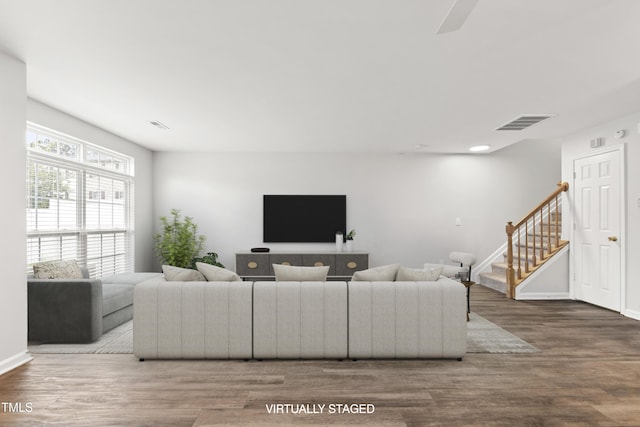 8610 Neuse Landing Ln Unit 103, Raleigh, NC 27616 - living room with stairs, wood finished floors, and baseboards