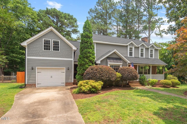 6304 Ansley Ln, Raleigh, NC 27612 - view of front facade with an attached garage, a porch, a chimney, and driveway