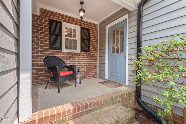 6304 Ansley Ln, Raleigh, NC 27612 - property entrance featuring brick siding and a porch