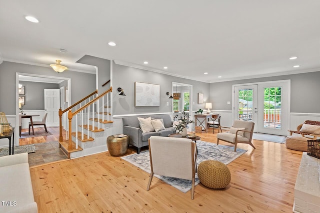 6304 Ansley Ln, Raleigh, NC 27612 - living area featuring ornamental molding, stairway, wood finished floors, wainscoting, and recessed lighting
