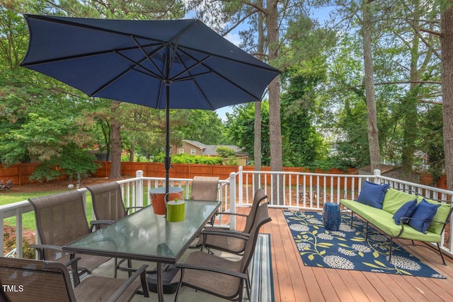 6304 Ansley Ln, Raleigh, NC 27612 - wooden deck with outdoor dining space and a fenced backyard