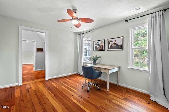6304 Ansley Ln, Raleigh, NC 27612 - office area featuring a ceiling fan, a textured ceiling, wood finished floors, and baseboards