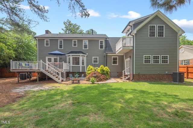 6304 Ansley Ln, Raleigh, NC 27612 - back of property with a fire pit, a chimney, a deck, central air condition unit, and a patio