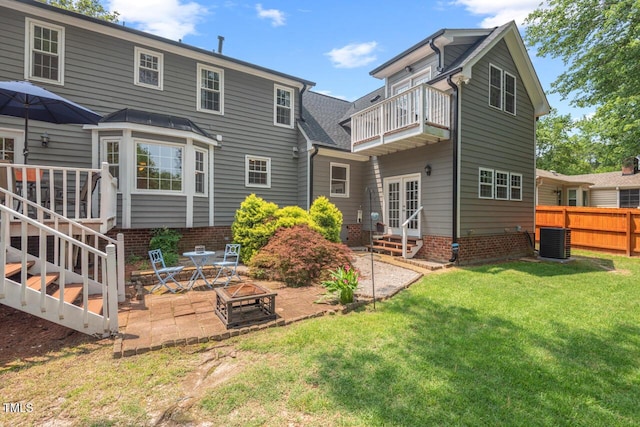 6304 Ansley Ln, Raleigh, NC 27612 - rear view of property with a balcony, a patio area, a fire pit, and french doors
