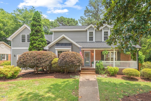 6304 Ansley Ln, Raleigh, NC 27612 - traditional home with covered porch, a front lawn, and roof with shingles