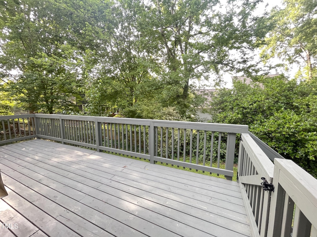 wooden deck with view of scattered trees