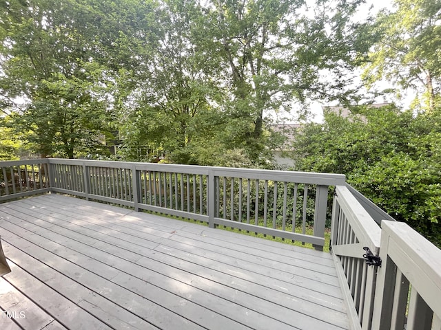 wooden deck with view of scattered trees