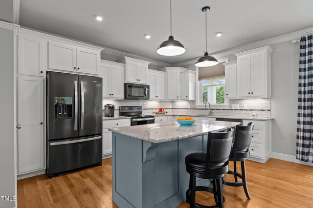 4564 Ashtons Way, Franklinton, NC 27525 - kitchen with fridge with ice dispenser, black microwave, stainless steel range with electric cooktop, white cabinets, and light wood-style flooring
